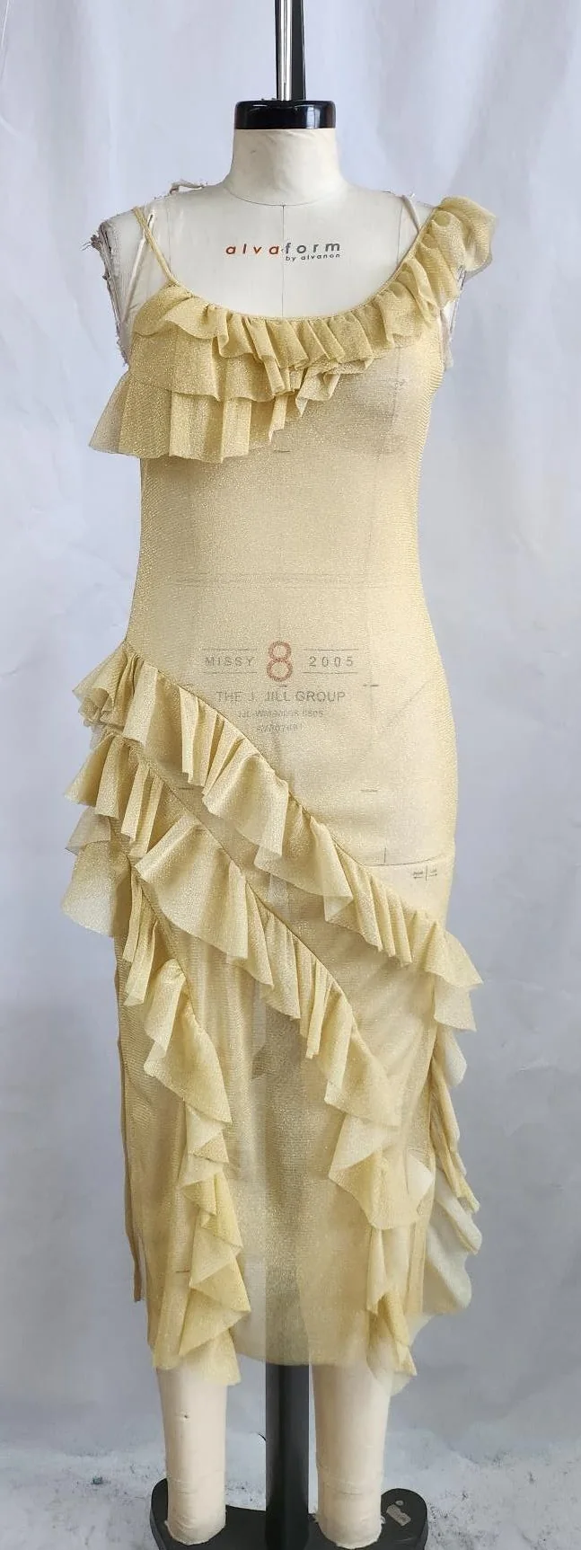 Sample of a long cream jersey dress with ruffled tiers on a fitting mannequin